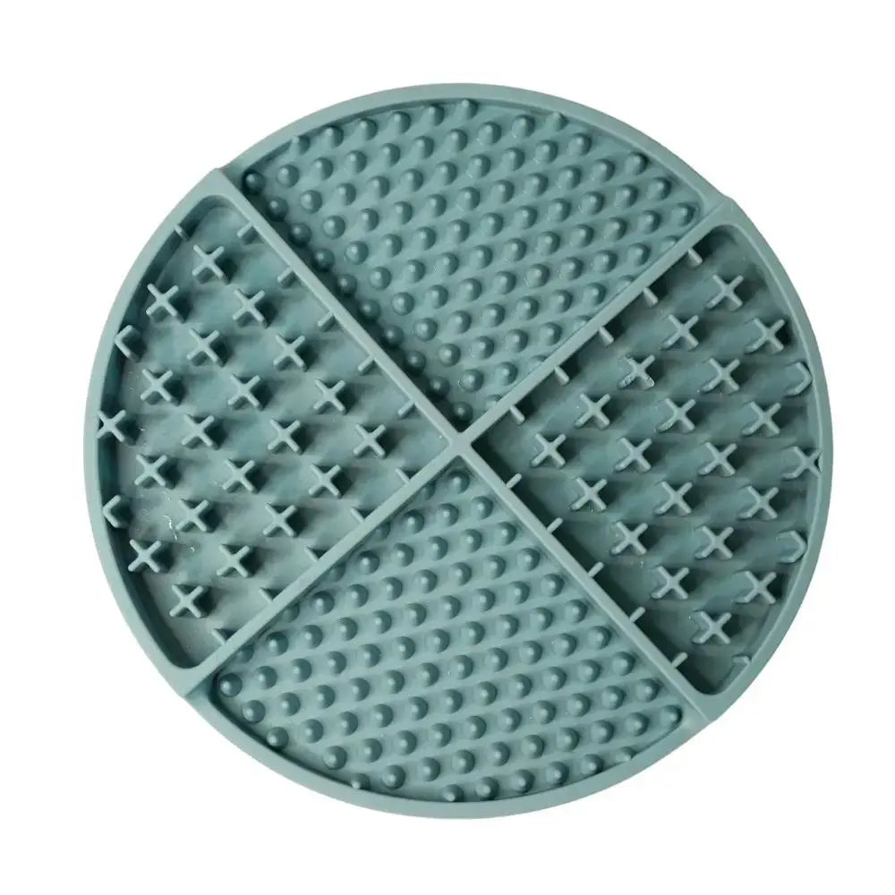 A round sage green silicone lick mat divided into four textured quadrants